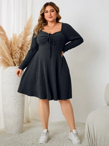 Close-up of ribbed knit texture and lace-up sweetheart neckline on the grey plus size dress