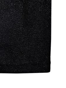 Macro detail of black knit fabric with glittering metallic fibers for evening dress