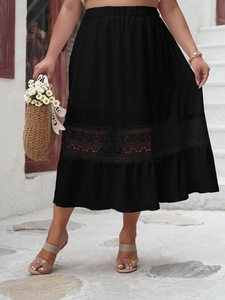 Detail of elegant high waist black midi skirt with hollow lace patchwork hemline