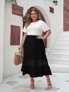 Detail of high waisted black midi skirt featuring hollow out lace patchwork and ruffles