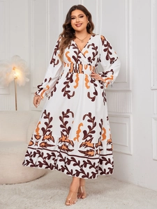 Detail view of V-neckline and abstract floral print on long sleeve boho maxi dress