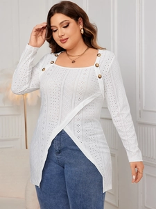 Detail shot of white plus-size blouse with hollow embroidery and button accents