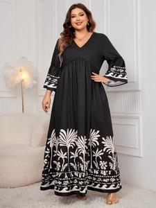 Detail of V-neck printed plus size maxi dress with bell sleeves and palm tree patterns