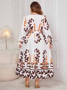 Rear view of a white floor-length maxi dress with orange botanical prints and ruffled hem