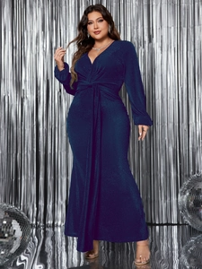 Close-up of glittery deep blue fabric with waist twist detail on elegant V-neck maxi dress