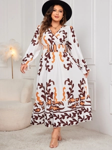 Detail of printed maxi dress with V-neck, vintage floral pattern, and high waist design