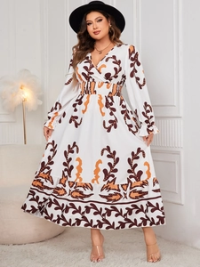 Detail of V-neck printed maxi dress featuring abstract vine patterns and smocked waist
