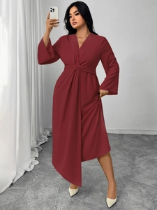 Detail of V-neck long-sleeve dress with waist wrap knot and irregular hem in burgundy