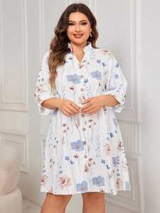 Detailed view of floral print pattern and wood-style buttons on a white midi shirt dress