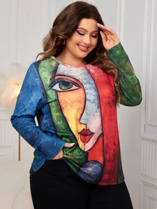 Detail of plus size long sleeve top with colorful abstract face art print on knit fabric
