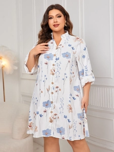 Detail of plus size white floral shirt dress with wood buttons and 3/4 sleeves