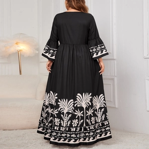 Elegant V-neck maxi dress with bell sleeves and white tropical palm prints on black fabric