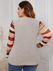 Detail view of grey ribbed knit texture and striped patchwork long sleeves for women