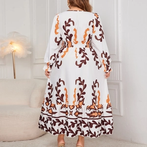 Bohemian floral maxi dress with long sleeves and tiered hem in white and orange