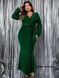 Detail of dark green V-neck evening dress showing sequined fabric and waist knot