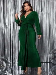 Detail view of the V-neck and decorative waist knot on a sparkling dark green evening gown