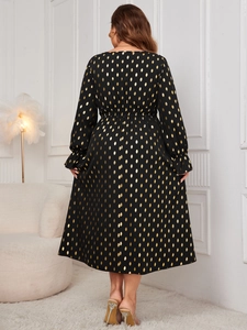 Rear view of long sleeve black maxi dress with golden foil polka dots and ruffle cuffs