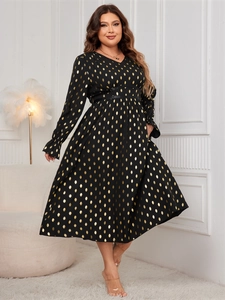 Detail of the V-neck high waist black dress with golden foil teardrop patterns