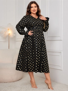 Detail of V-neck plus size maxi dress with metallic gold polka dot pattern and high waist