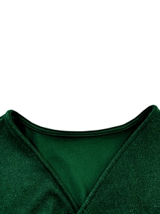 Macro shot of V-neckline on dark green evening dress with sparkling glitter texture