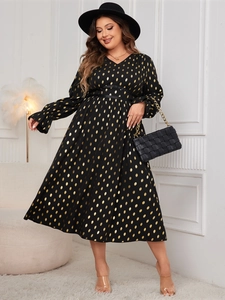 Detail of V-neck maxi dress featuring gold foil polka dots and elegant cinched waist