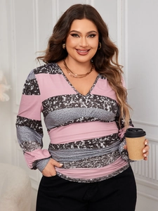 Close-up of pink and grey striped plus size V-neck top with sparkling sequin detailing