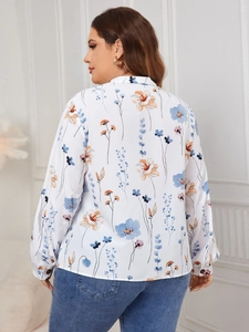 Detail of floral printed long sleeve shirt for women with blue and orange abstract pattern
