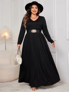 Detail view of a black V-neck maxi dress with a vintage gold buckle waist belt