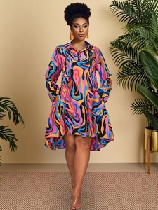 Detail of high-low hem and psychedelic ripple print on long sleeve polo dress
