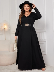 Detail of high-waist plus size black maxi dress with a wide decorative gold buckle belt