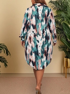 Detail view of plus size shirt dress with abstract watercolor print and curved hemline