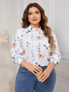 Close-up of floral print blouse with asymmetric buttoned collar and high neckline detail