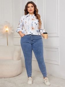 Detail of plus size long sleeve shirt with floral prints and decorative neck buttons