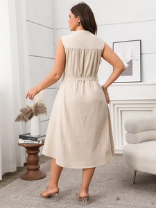 Back view of a slim-fit sleeveless beige dress with waist belt and pleated details