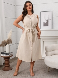 Detailed close-up of a beige sleeveless midi dress with retro buttons and linen texture