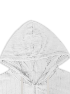 Detail of white striped knit hoodie featuring zipper closure and drawstring texture