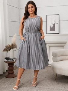 Detail of grey and white striped sleeveless dress featuring elastic waist and side pockets