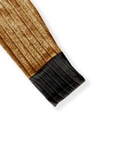 Detail shot of striped velvet fabric cuffs with premium stitching and gold-black contrast