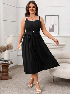 Detail of black square neck dress with white wave trim and decorative buttons