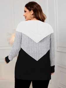 Detail of hooded knit cardigan featuring black white grey color block chevron pattern