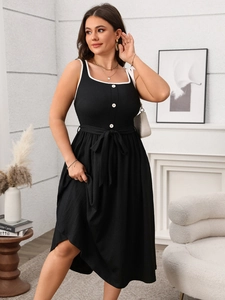 Detail of elegant black sleeveless midi dress with white lace trim and contrast buttons