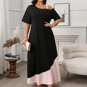 Detail of a cold shoulder color-block dress with asymmetric hem and pink patchwork