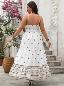 Detail of bohemian white sundress featuring intricate ethnic prints and smocked back design