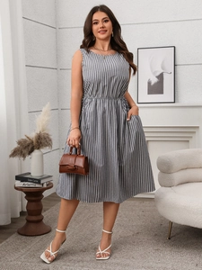 Detail view of sleeveless striped dress featuring side pockets and elastic waist design
