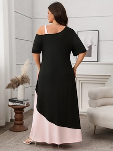 Detail showing asymmetric contrast color stitching and off-shoulder design on a dress