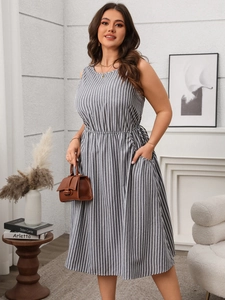 Detail of grey striped sleeveless dress showing side pockets and elastic high waist texture