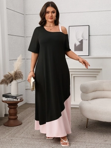 Detail of off-shoulder neckline and asymmetric pink strap on black maxi dress