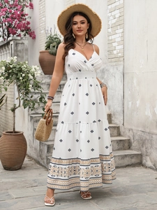 Detail of bohemian white sundress with blue geometric prints and ethnic hem decoration