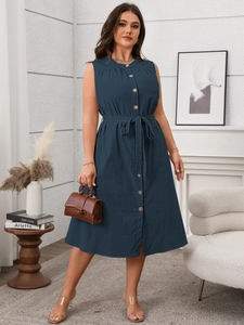 Detail view of navy blue sleeveless midi dress with wood buttons and pleated neckline