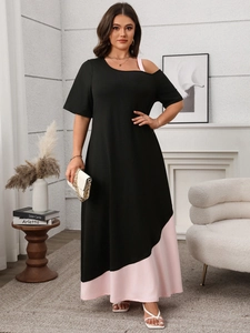 Detail of color block dress with black fabric and pink hemline in an A-line silhouette